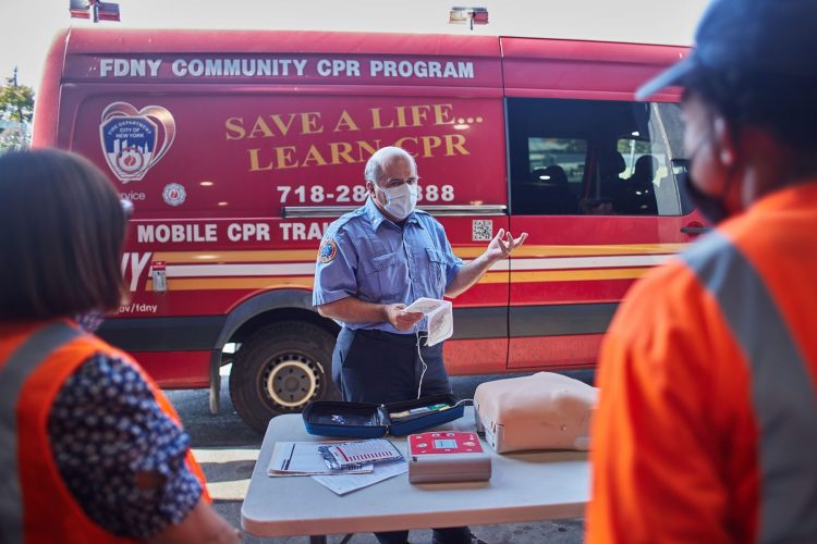 A FDNY Mobile CPR Training Unit instructor explains proper AED use.